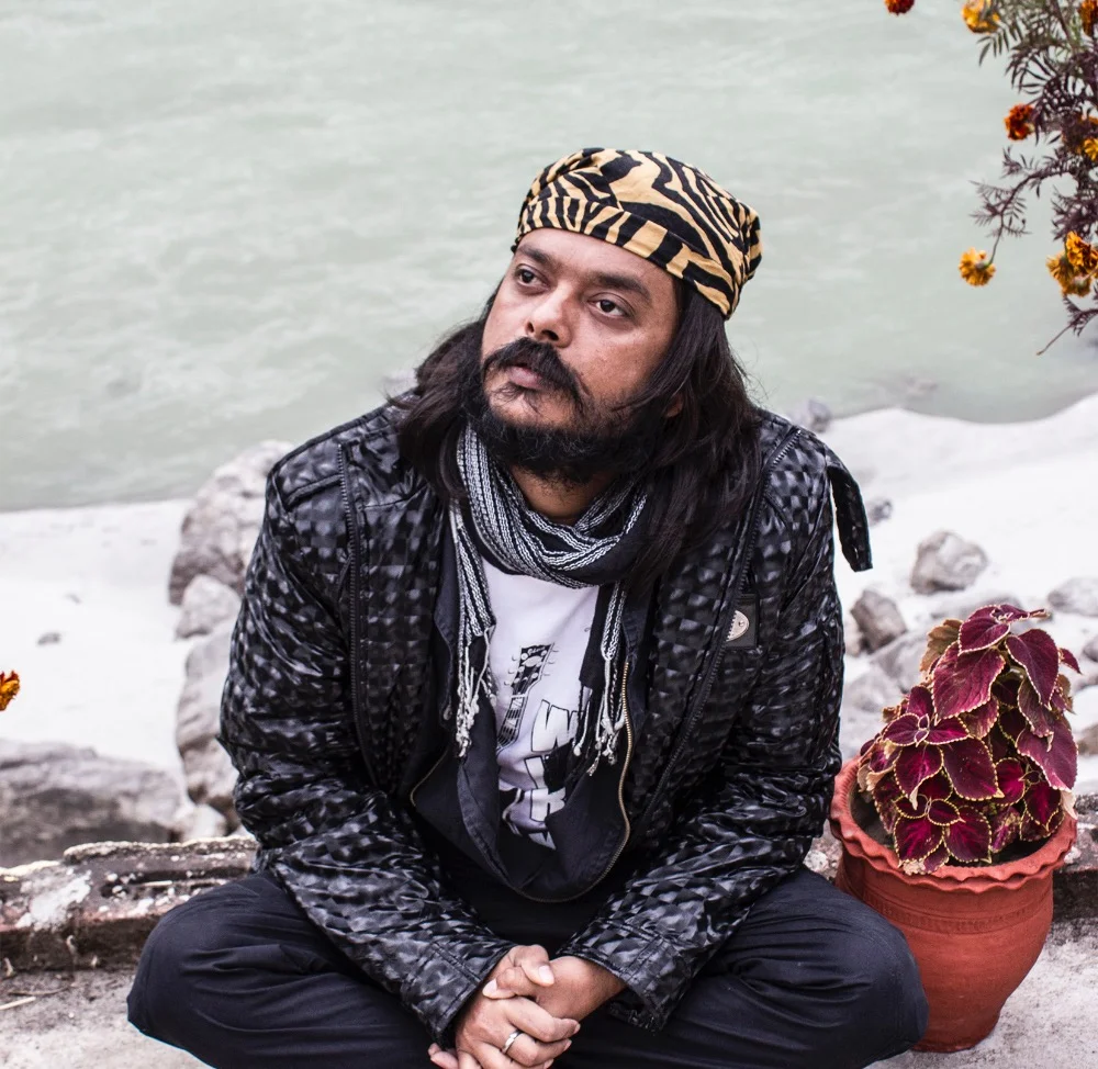 Swami Shrila Prem Paras seated beside the water
